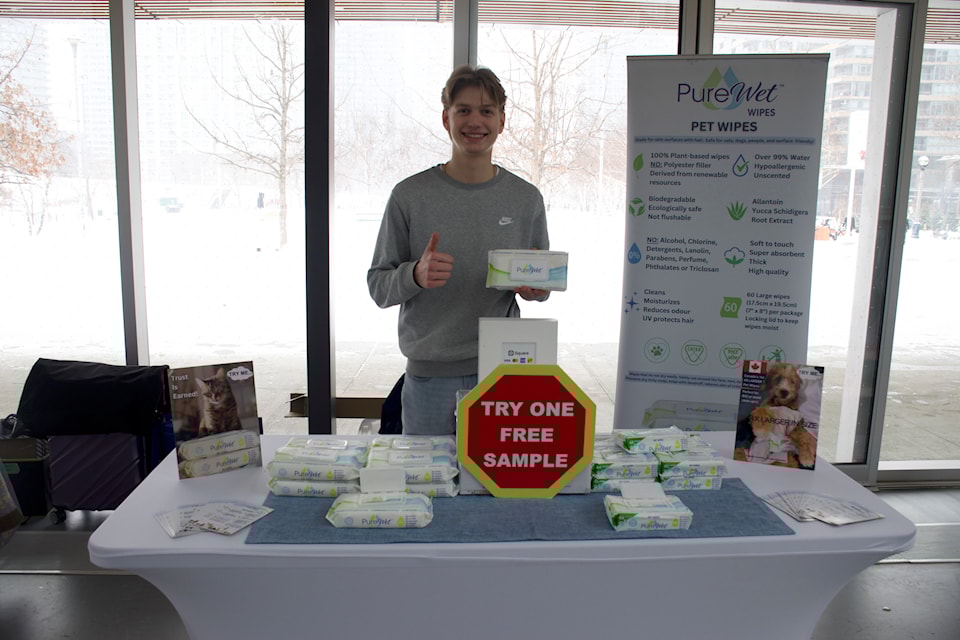 Daniel Romaniuk standing behind his booth where he was selling his WetWipes products.