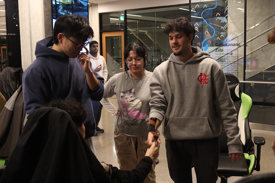 The Humber Valorant team. From left, Michael Xu, Tia Kelsey, and Arthur Gaudio at this year's Canadian Esports National tournament. Gaudio said he injured his wrist in a skateboarding accident when he was younger. HumberETC/Julia-Marie Ilano