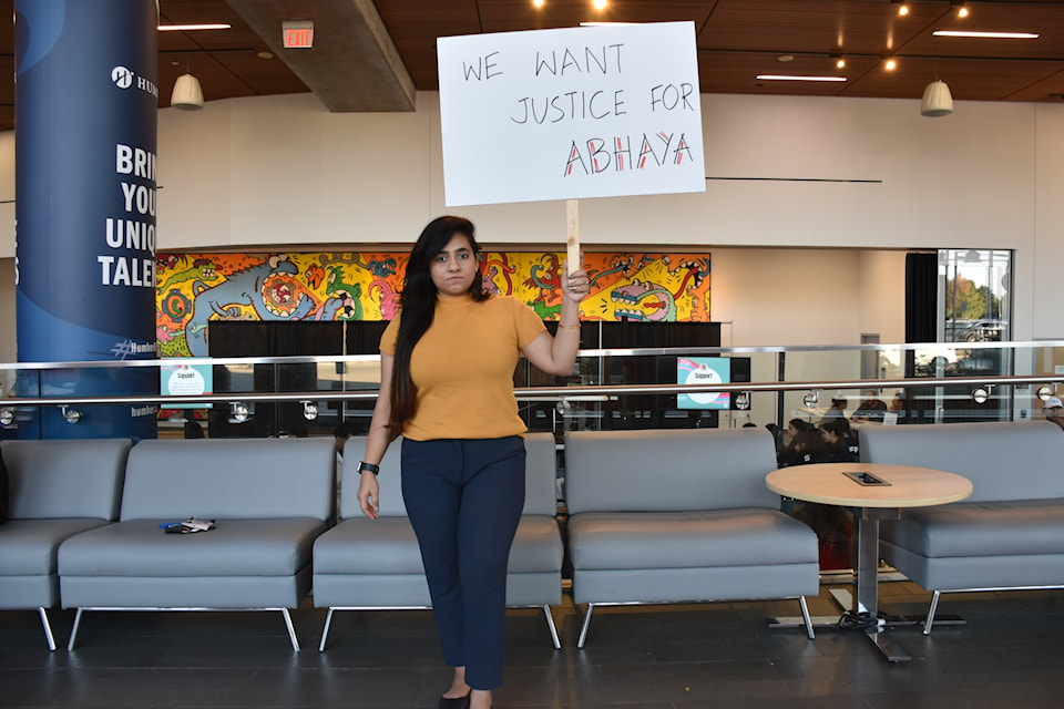 Woman holding up a sign in Take Back the Night protest.