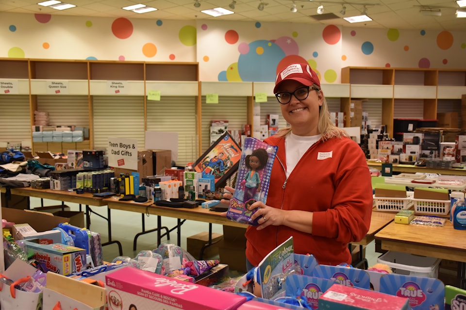 Sarah Rutka, co-founder of Holiday Helpers, showcasing kids' toys about to be wrapped up.