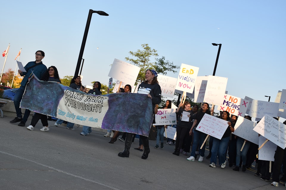 Students protest with a banner outside.