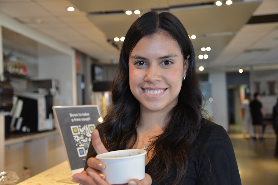 The student Advocate of IGNITE holding soup 