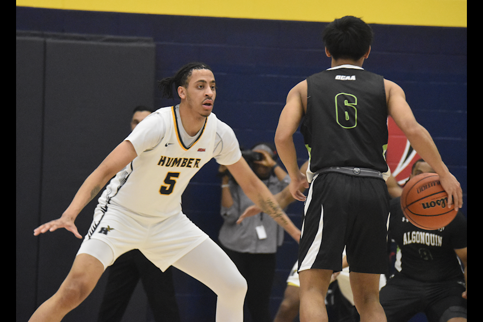 Humber Hawks forward Malik Grant guards Wolves guard Jansen Balmaceda in a game against Algonquin on Feb. 23.