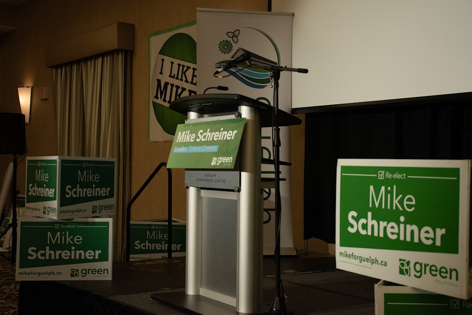 The stage where Mike Schreiner gives his speech stands empty, with posters of his name decorating the space.