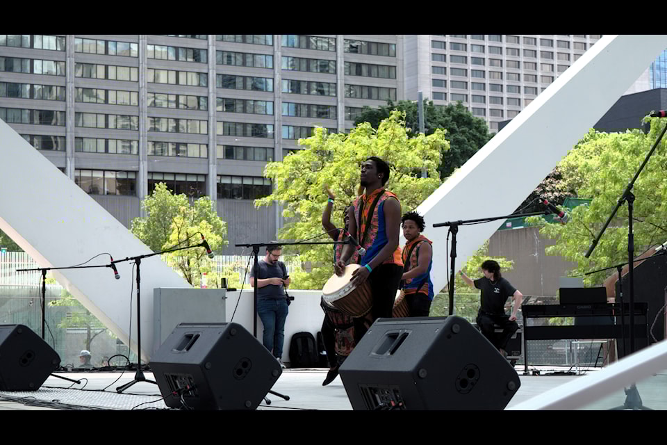 Members of The Ngoma Ensemble playing the drums for a performance in Toronto's Newcomer Day event.