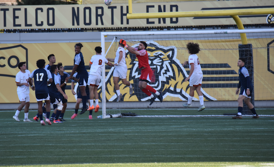 Humber's men soccer goalie makes a save.