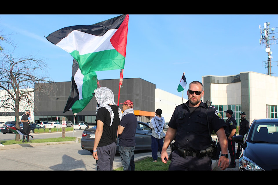 Protesters holding Palestinian flags at the protest site in Brampton outside the Banquet Hall where Miller's fundraiser was being held on June 3. Police officers were present at the site asking the protesters to step away from the "private property."