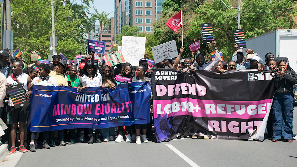 rainbow-week-of-action-parade-walkers-holding-banner