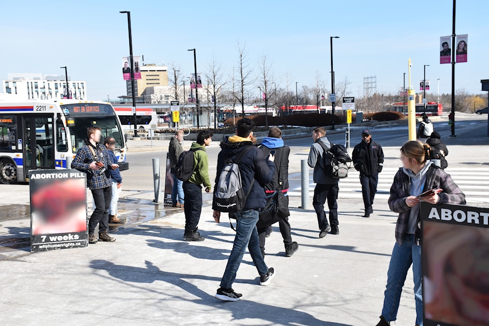 People gathered at Humber’s North campus talking about abortion in a pro-life protest on March 10. The volunteers' faces are blurry because they are minors. The images in the posters are blurry because of sensitive content.